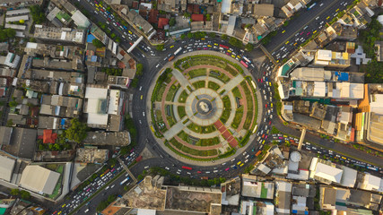Road roundabout with car lots Wongwian Yai in Bangkok,Thailand. street large beautiful downtown at evening light.  Aerial view , Top view ,cityscape ,Rush hour traffic jam.