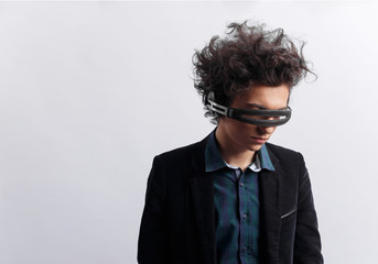 Sad young man with headphones on eyes, picture in profile, dressed in shirt and jacket, listen to music on white background. Space for text.