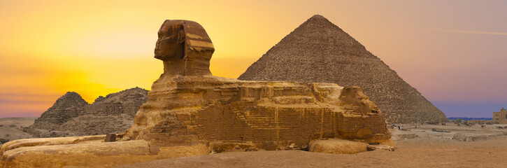 Sphinx against the backdrop of the great Egyptian pyramids. Africa, Giza Plateau. - obrazy, fototapety, plakaty