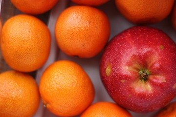 Ripe apples and oranges on the table