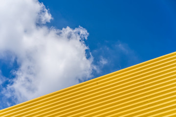 Yellow roof against blue sky.
