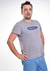 Fototapeta premium Young man wearing a t-shirt, smiling isolated on white 