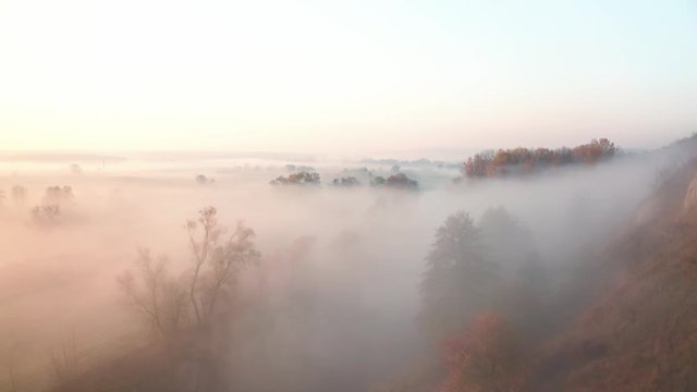 Haze above river in autumn landscape