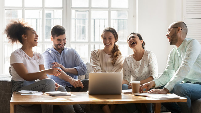 Smiling multiethnic young people have fun studying together
