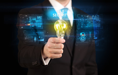 Businessman holding lightbulb with FILE SECURITY inscription, online security idea concept