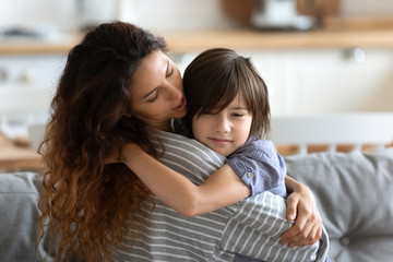 Mom embracing little son express care and love soothing him