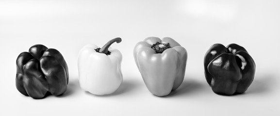 Unique Black and White peppers on a white surface