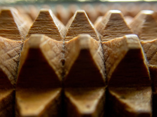 Macro of a wooden massage tool - wooden spikes/pyramids background (selective focus effect)