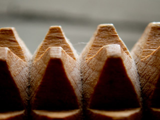 Macro of a wooden massage tool - wooden spikes/pyramids background (selective focus effect)