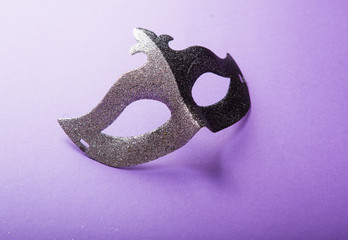 A festive, colorful group of mardi gras or carnivale mask on a purple background. Venetian masks.