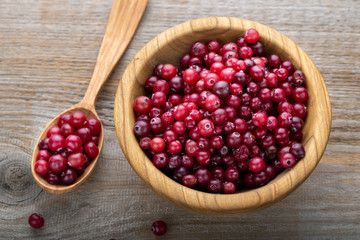 raw cranberries in a wooden plate