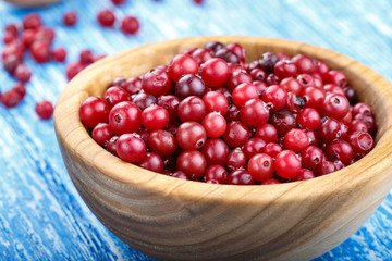 raw cranberries in a wooden plate