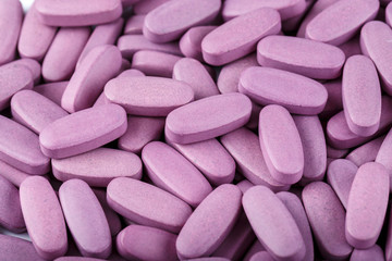 Obraz na płótnie Canvas Many lilac tablets close up.