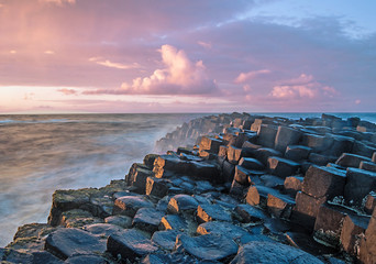 Sunset with the Giant's Causeway in the foreground - obrazy, fototapety, plakaty