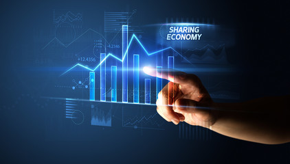 Hand touching SHARING ECONOMY button, business concept