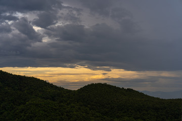 Mountain scape against sunset sky.