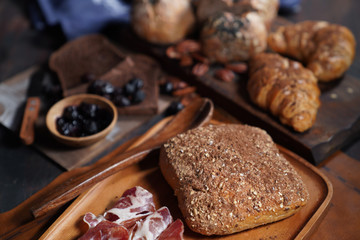 Bacon, baguette on wooden tray.