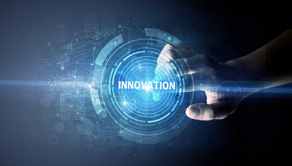 Hand touching INNOVATION button, modern business technology concept
