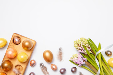 Flat lay, top view of Easter golden eggs and decorations on gray background. Easter concept