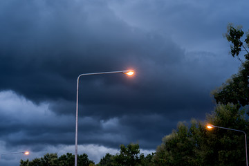 Lantern against dark cloud sky.