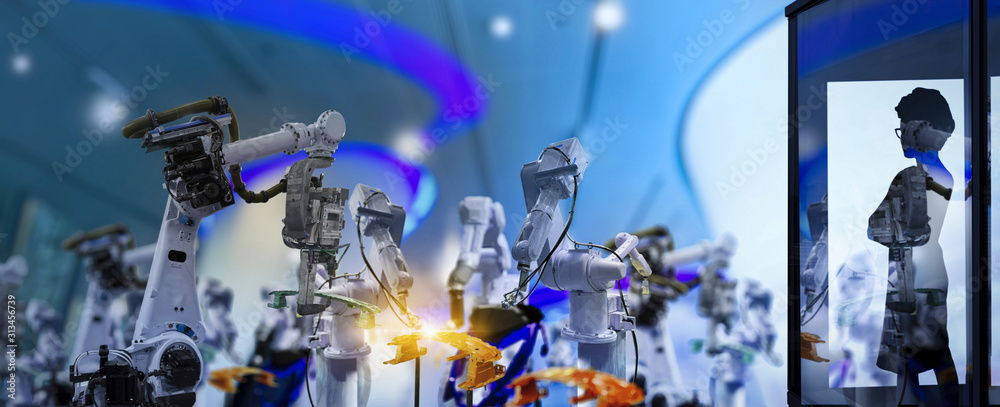 Poster Factory Female Industrial manager Engineer looking at automation robot arms machine in intelligent factory industrial on real time monitoring system software.