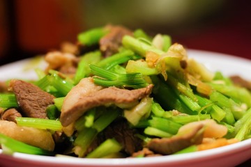 Chinese food: Pork stir fry with celery green vegetable close up