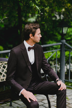 Close-up portrait of handsome young bridegroom with elegant stylish haircut