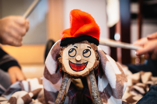 caga ti&oacute;, Catalan Christmas tradition tree trunk that is beaten with sticks, with painted face and barrette, covered with a blanket