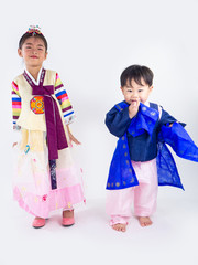 Asian little boy and girl wearing a Korean Traditional Hanbok dress in Rattan bag on white background