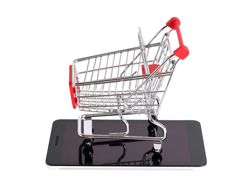 Supermarket trolley and smartphone on white background