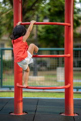 Fototapeta premium Cute asian girl playing at playground in summer.