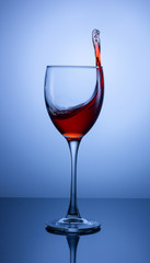 splash in a glass of red wine on a gradient background