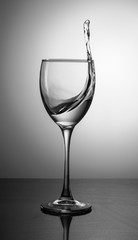 splash of clear clear water in a glass on a gradient background
