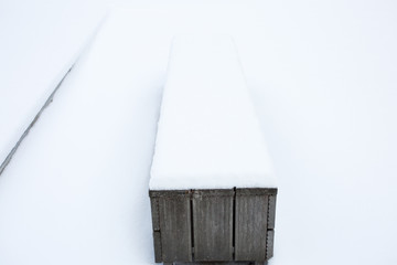 wooden bench in the snow