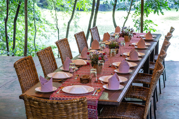 Served table and rattan chairs in an empty restaurant terrace. Tanzania, Africa