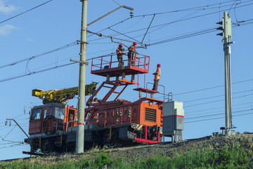 Fototapeta na wymiar Electric railway. A machine to repair the contact chain.