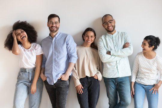 Overjoyed multiracial young people posing for group picture
