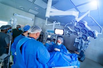 Team surgeon at work in operating room. Modern equipment in operating room. Medical devices for neurosurgery.