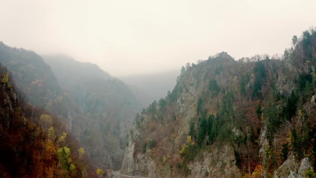Landscape of misty mountains with Poenari Castle on top