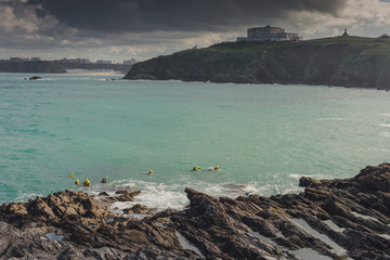 Group of people learning to swim under dark sky