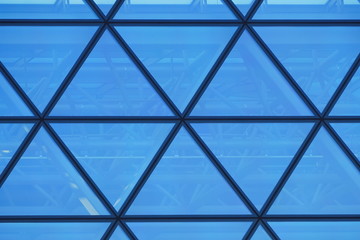 blue glass facade of modern office or public building made of id
