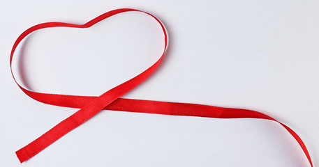 Red ribbon heart isolated on white background. Red ribbon in heart shape.