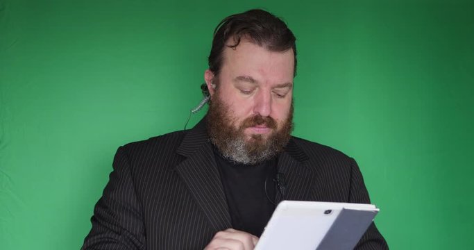 Portrait of bearded bouncer in front of green screen