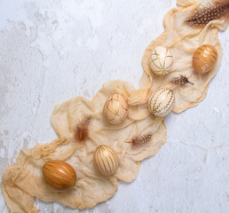 Easter composition. Chicken eggs in golden stripes on a yellow cloth. Warm yellow tones. Religious...