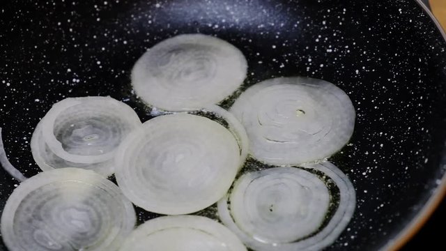 Onion fried in a black teflon pan in olive oil, meal.