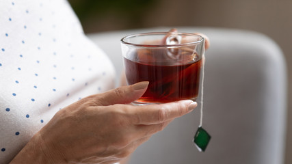 Close up of mature woman enjoying black tea