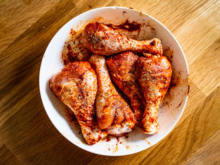 Marinated raw chicken drumsticks ready for grill