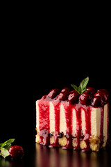 Sliced No Bake Strawberry Cheesecake Decorated with cherries and Mint, black background capy paste space