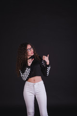 Young girl model posing with cute racing sweater in black background