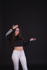 Young girl model posing with cute racing sweater in black background